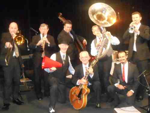 The 8-piece 1920s Greg Poppleton and his Bakelite Broadcasters. (L-r) Al Davey trumpet doubling trombone, Paul Furniss (clarinet doubling alto sax) Stan Valacos (double bass) Cazzbo Johns (sousaphone) Bradley Newman (holding the tp, piano) Greg Poppleton (1920s singer and megaphone) Grahame Conlon (guitar and banjo) Alex Inman Hislop (drums).